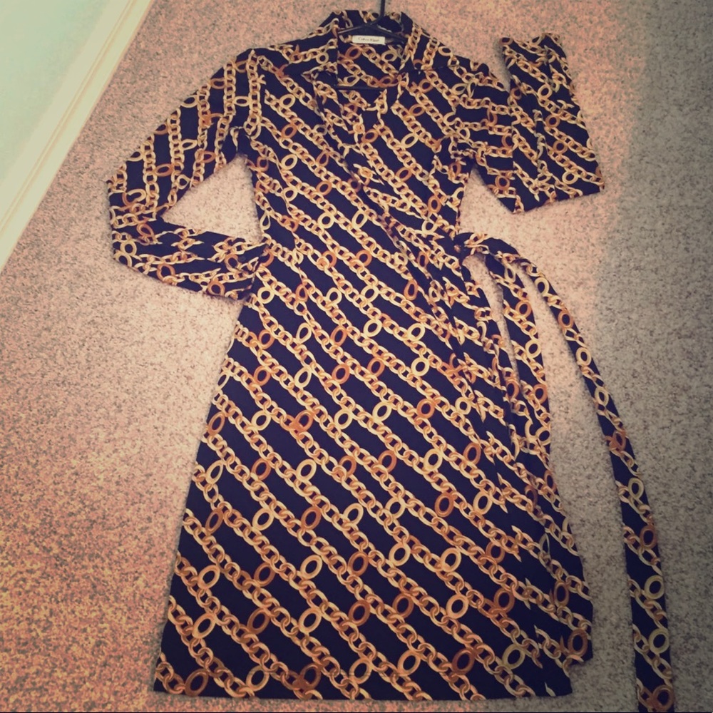 Awesome CK long sleeved wrap dress in black & gold